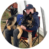 OFP member Tiffany holding her service dog Atlas